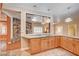 Bright kitchen features granite countertops, natural wood cabinets and view into a stone fireplace at 3015 Duneville St, Las Vegas, NV 89146