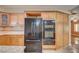 Wood cabinets surround black appliances in this well-designed kitchen with granite countertops at 3015 Duneville St, Las Vegas, NV 89146
