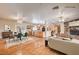 Bright living room with hardwood floors, stone fireplace, kitchen and dining area in an open concept design at 3015 Duneville St, Las Vegas, NV 89146
