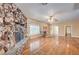 Spacious living room with stone fireplace and mantel, hardwood floors, and natural light at 3015 Duneville St, Las Vegas, NV 89146