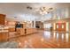 Open-concept floor plan showcases hardwood floors, stone fireplace and kitchen with an island at 3015 Duneville St, Las Vegas, NV 89146