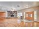 Spacious living room with hardwood floors, a stone fireplace, and natural light at 3015 Duneville St, Las Vegas, NV 89146