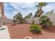 Beautifully landscaped backyard with desert plantings and trees, creating a peaceful outdoor oasis at 3239 Robins Creek Pl, Las Vegas, NV 89135