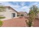 Desert landscaped backyard with trees and vegetation; also features a covered patio at 3239 Robins Creek Pl, Las Vegas, NV 89135