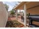 This backyard includes a garden bed with flowers and a charming covered patio area for relaxation and outdoor enjoyment at 3239 Robins Creek Pl, Las Vegas, NV 89135