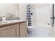 Bright bathroom featuring a single sink vanity with granite countertops and a shower-tub combo at 3239 Robins Creek Pl, Las Vegas, NV 89135