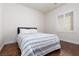 Cozy bedroom with a queen bed and hardwood floors, bathed in natural light from a window at 3239 Robins Creek Pl, Las Vegas, NV 89135