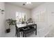 Dining area with white walls, a gray table with a bench, and plantation shutters at 3239 Robins Creek Pl, Las Vegas, NV 89135
