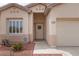Close up of the front exterior of home with neutral paint, xeriscaping, and a two car garage at 3239 Robins Creek Pl, Las Vegas, NV 89135