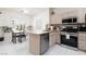Kitchen with stainless steel appliances, light wood cabinetry, granite countertops, and white tile floors at 3239 Robins Creek Pl, Las Vegas, NV 89135