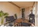 Cozy covered patio featuring ample seating, table, grill and sliding door access to the home's interior at 3239 Robins Creek Pl, Las Vegas, NV 89135