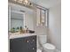 Stylish bathroom with a dark vanity, white countertop, and well-lit mirror, offering a modern and clean aesthetic at 3257 Coral Harbor Dr, Las Vegas, NV 89117