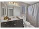 Bathroom features a modern vanity with a neutral countertop and a shower with a gray curtain at 3257 Coral Harbor Dr, Las Vegas, NV 89117