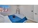 Well-lit bedroom with a plush blue comforter and serene window view, creating a relaxing and inviting atmosphere at 3257 Coral Harbor Dr, Las Vegas, NV 89117