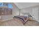 Bedroom features a bed with a striped blanket, wood flooring, and an arched window at 3257 Coral Harbor Dr, Las Vegas, NV 89117