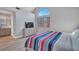 Bright bedroom featuring wood-look flooring, a TV, and a large, arched window at 3257 Coral Harbor Dr, Las Vegas, NV 89117