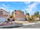 Charming home featuring a two-car garage and desert landscaping at 3257 Coral Harbor Dr, Las Vegas, NV 89117