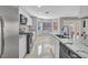 Contemporary kitchen featuring stainless steel appliances, marble counters, and ample natural light, offering both style and functionality at 3257 Coral Harbor Dr, Las Vegas, NV 89117