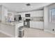 Modern kitchen features white cabinets, stainless steel appliances, marble countertops, and sleek, open design at 3257 Coral Harbor Dr, Las Vegas, NV 89117