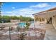 Backyard view showcases a stone patio, pool, lush plants and flowers creating an outdoor oasis for relaxing at 3334 W Mardon Ave, Las Vegas, NV 89139