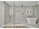 Luxurious bathroom features a glass shower, a rainfall showerhead, and a modern tub for ultimate relaxation at 3334 W Mardon Ave, Las Vegas, NV 89139