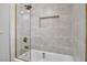 Stylish bathroom featuring a shower over tub with gold fixtures and decorative tiling at 3334 W Mardon Ave, Las Vegas, NV 89139
