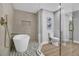 An opulent bathroom featuring a glass enclosed shower, stylish fixtures and a chic soaking tub with a tile surround at 3334 W Mardon Ave, Las Vegas, NV 89139