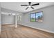 Bright bedroom with wood floors, sliding closet doors, and a large window with backyard views at 3334 W Mardon Ave, Las Vegas, NV 89139