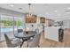 Bright dining area with view to a pool, open to the kitchen and sitting area at 3334 W Mardon Ave, Las Vegas, NV 89139