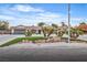 Charming single-story home featuring a well-manicured lawn, mature landscaping, and a three-car garage at 3334 W Mardon Ave, Las Vegas, NV 89139