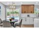 Eat-in kitchen featuring modern light fixture, gray chairs, and pool view at 3334 W Mardon Ave, Las Vegas, NV 89139