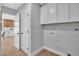 Bright laundry room with white cabinets and modern fixtures, adjacent to kitchen area at 3334 W Mardon Ave, Las Vegas, NV 89139