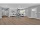 Bright living room boasts wood floors, a ceiling fan, and modern decor, creating an inviting space at 3334 W Mardon Ave, Las Vegas, NV 89139