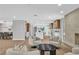 Bright, open living area featuring modern furniture, a fireplace, and seamless flow to kitchen and dining spaces at 3334 W Mardon Ave, Las Vegas, NV 89139