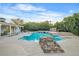 A backyard pool featuring rock waterfall and lush mature landscaping at 3334 W Mardon Ave, Las Vegas, NV 89139