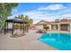 A well-maintained pool area with a gazebo and lush, mature landscaping at 3334 W Mardon Ave, Las Vegas, NV 89139