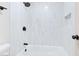Stylish bathroom features a shower over tub with white tile and black shower head at 3339 Duece St, Las Vegas, NV 89121