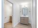 Well-lit bathroom with wood vanity, modern mirror and fixtures, and wood-look flooring at 3339 Duece St, Las Vegas, NV 89121