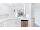 Modern kitchen with white cabinets, stainless steel appliances, and a view to the backyard through sliding glass doors at 3339 Duece St, Las Vegas, NV 89121
