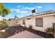 Backyard area with desert landscaping and a tile roof line on the home at 3517 S Dapple Gray Rd, Las Vegas, NV 89147