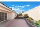 Backyard has concrete and rock landscaping, a brick wall, and a beautiful blue sky at 3517 S Dapple Gray Rd, Las Vegas, NV 89147