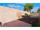 Fully fenced backyard featuring desert landscaping and a large wall at 3517 S Dapple Gray Rd, Las Vegas, NV 89147
