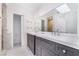 Bathroom featuring double sinks, gray cabinets, and a large mirror at 3517 S Dapple Gray Rd, Las Vegas, NV 89147