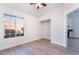 Bright bedroom with light wood-look floors, a ceiling fan, and a view through the window at 3517 S Dapple Gray Rd, Las Vegas, NV 89147