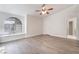 Large bedroom with modern ceiling fan, arch window and light wood-look flooring at 3517 S Dapple Gray Rd, Las Vegas, NV 89147