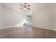 Spacious bedroom with modern ceiling fan, arch window and light wood-look flooring at 3517 S Dapple Gray Rd, Las Vegas, NV 89147