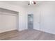 A bright bedroom with neutral walls, light wood-look floors and a door that opens into another room at 3517 S Dapple Gray Rd, Las Vegas, NV 89147