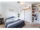 Cozy bedroom with built-in shelves and a sliding door closet for optimal storage at 3661 Margarita Way, Las Vegas, NV 89103