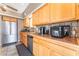 Kitchen with stainless steel appliances, wooden cabinets, and modern countertops for a sleek cooking space at 3661 Margarita Way, Las Vegas, NV 89103