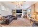 Open living room featuring a large window, fireplace and built in shelving for a modern look at 3661 Margarita Way, Las Vegas, NV 89103